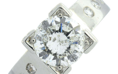 An platinum brilliant-cut diamond single-stone ring, with brilliant-cut diamond shoulders.