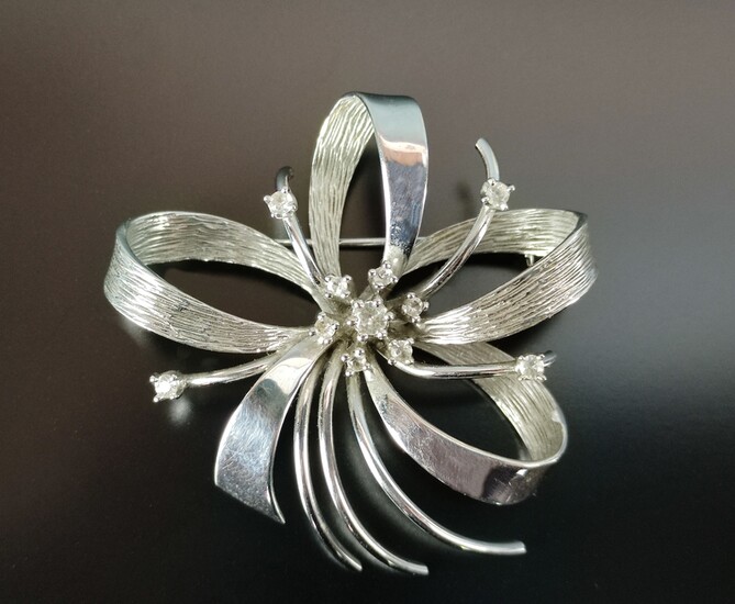 Brooch, flower-shaped, with arched curved elements, set with 11 cubic zirconia in total, 585/14K wh