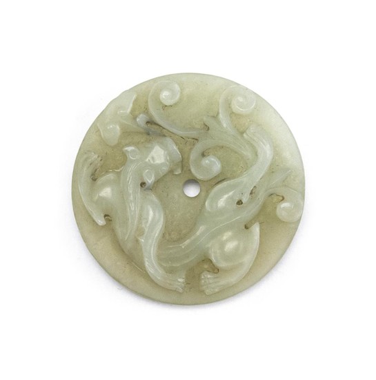 CHINESE WHITE JADE BI In disk form, with relief qilong dragon on obverse and scroll designs on reverse. Diameter 2.2".
