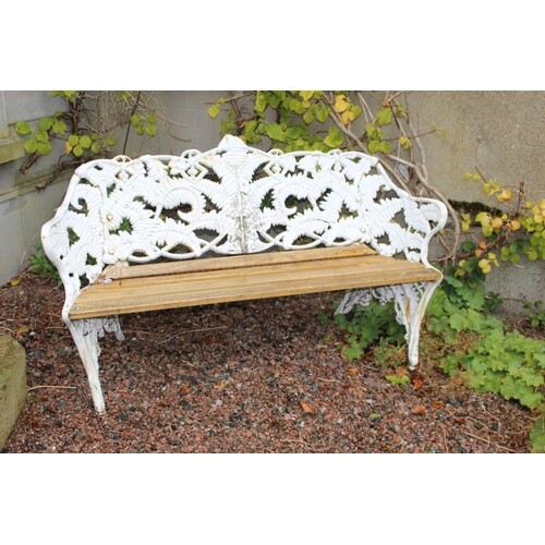 Cast iron garden bench with fern decoration on back and slat...