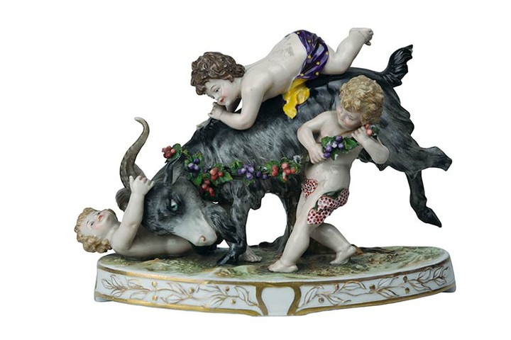 Goat with cherubs Group with three cherubs playing on the...