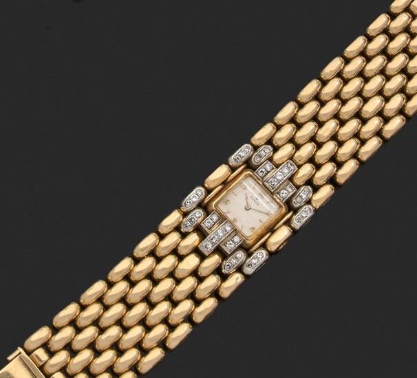 Large ARTICULATED ribbon BRACELET in gold and platinum, adorned at the centre with a square bracelet watch with mechanical movement in attachments set with brilliants and diamonds eight-eight. The monogrammed clasp. The dial, the watch plate and the...