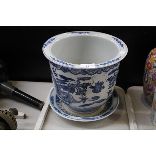 Old Chinese blue and white dragon jardiniere on under dish, ...