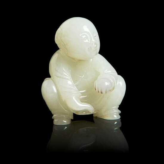 PALE CELADON JADE CARVING OF A SQUATTED BOY QING