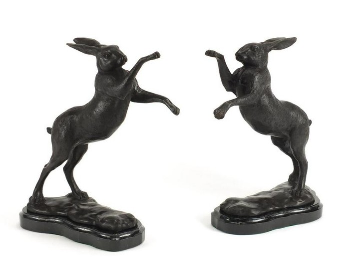 Pair of patinated bronze hares raised on shaped marble