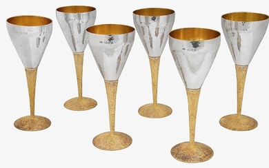 Stuart Devlin. An Elizabeth II Modernist set of silver and parcel-gilt goblets