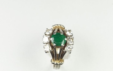 Yellow gold ring 18 carats 750 thousandths and platinum set with an emerald in an entourage of brilliants Gross weight 4 grs