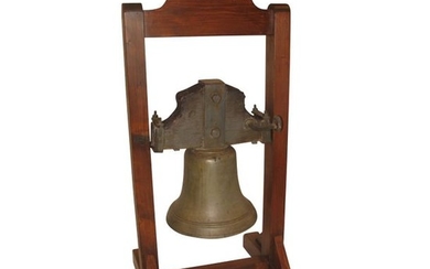 1 Cast iron bell with wooden stand.