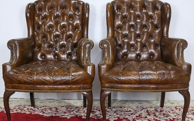 A pair of Georgian style wing chairs