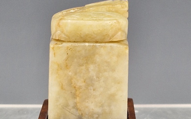 A CHINESE NEPHRITE JADE SEAL AND WOOD STAND, THE FORMER CARVED WITH A FOUR CHARACTER MARK AND TOPPED