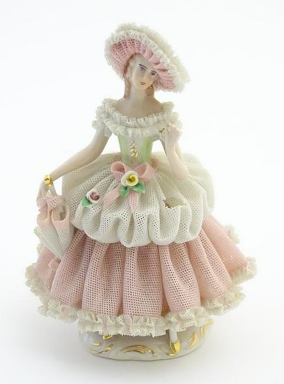 A Dresden porcelain figure of a lady wearing a