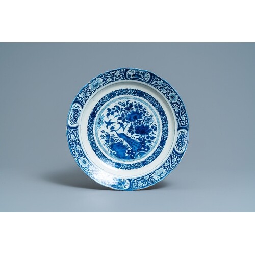 A Dutch Delft blue and white dish with a peacock in a Chines...