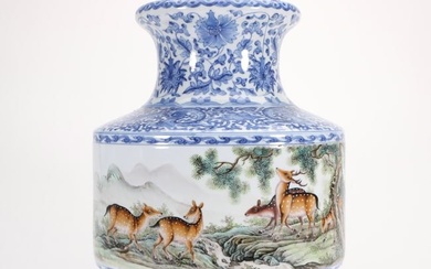 A Famille rose and blue and white vase with dragons, pines, and deer