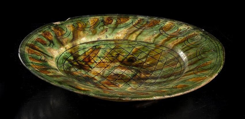 A GLAZED AND INCISED CERAMIC DISH Iran, 9th-10th