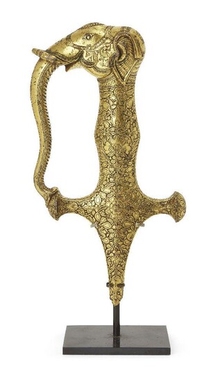 A Kutch finely chased gold sword hilt in the form of an elephant (talwar), India, late 18th-early 19th century, with a delicate and dense design of stylised flowers and geometric borders below an elephants head which acts as both the pommel and...