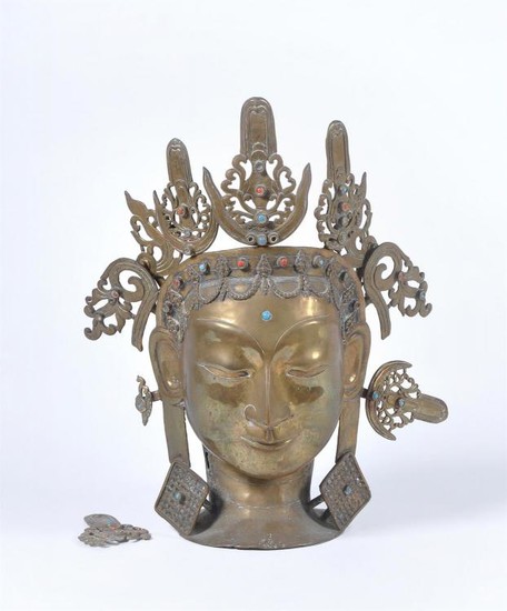 A Nepalese cast brass head of a Hindu deity
