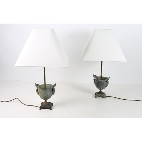 A PAIR OF BRONZE TABLE LAMPS each of urn form with figural m...