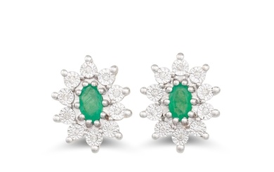 A PAIR OF DIAMOND AND EMERALD CLUSTER EARRINGS, the oval eme...