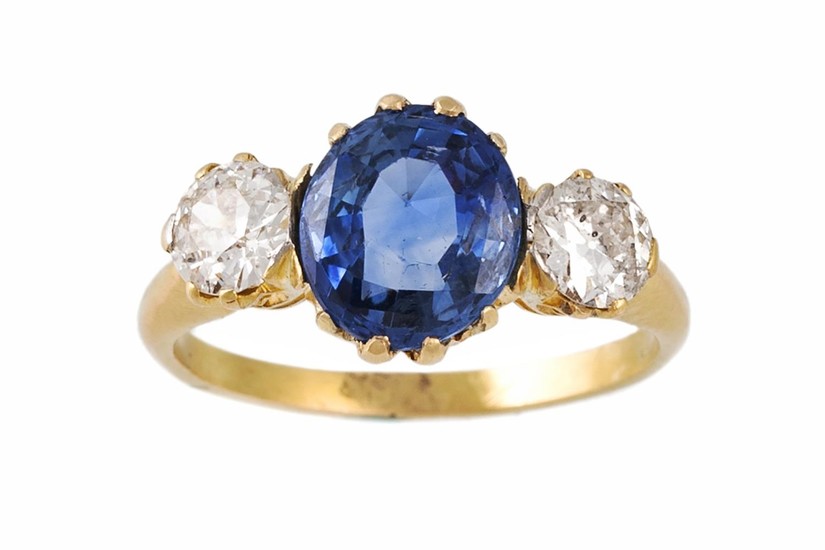 A SAPPHIRE AND DIAMOND THREE STONE RING, one oval cut sapphi...