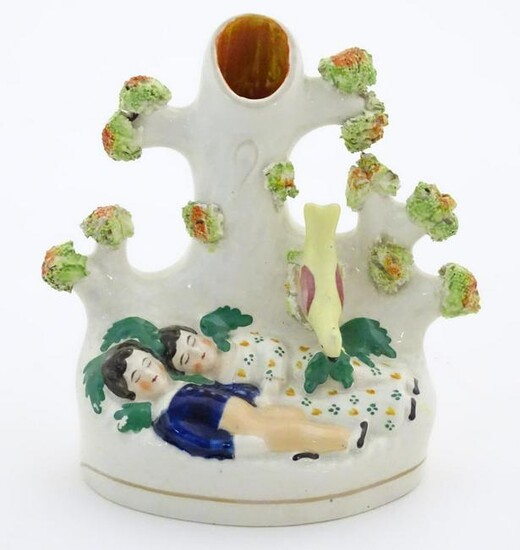 A Staffordshire pottery bud vase with two sleeping
