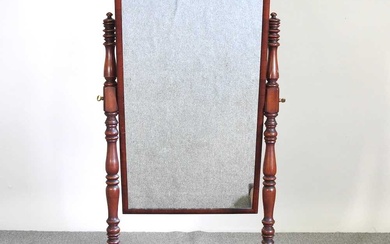 A Victorian mahogany cheval mirror, with turned supports, on scrolled...