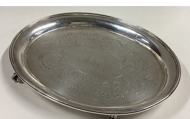 A Victorian silver teapot stand with bright-cut decoration. ...