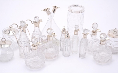 A collection of glass bottles and jars with silver mounts