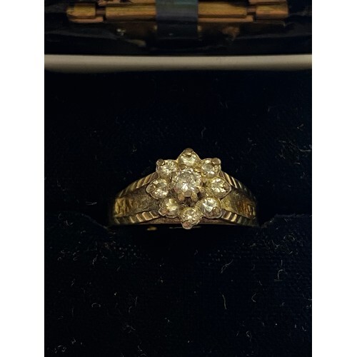 A diamond cluster ring, set in yellow gold (shank cut)