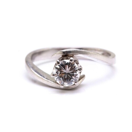 A diamond solitaire bypass ring in platinum, featuring a bri...