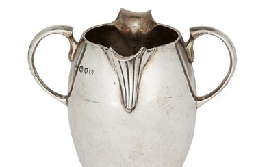 A double lipped Victorian silver cream jug, London, c.1890, George Fox, the fluted lips to a plain, rounded body with semi-circular twin handles, 7.2cm high, approx. weight 4.5oz