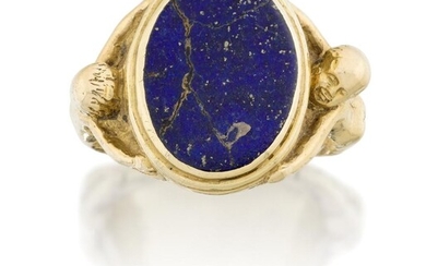 A lapis lazuli signet ring, the oval lapis panel in reed bezel the shoulders modelled as two nude figures, spurious inscription, lapis cracked, approx. ring size N