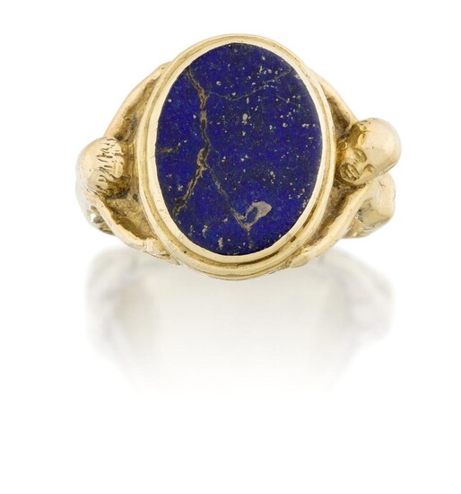 A lapis lazuli signet ring, the oval lapis panel in reed bezel the shoulders modelled as two nude figures, spurious inscription, lapis cracked, approx. ring size N