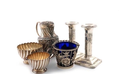 A mixed lot of silver items, various dates and makers, comprising: a swing-handled basket, London 1916, tapering wire-work body with birds and flowers and with a blue glass liner, plus a cream jug and sugar bowl, London 1893, a pair of candlesticks...