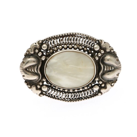 A mother of pearl brooch set with an oval piece of mother of pearl, mounted in sterling silver. 4.2×6 cm.