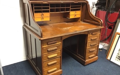 An Edwardian mahogany rolltop desk with panelled sides and tambour...