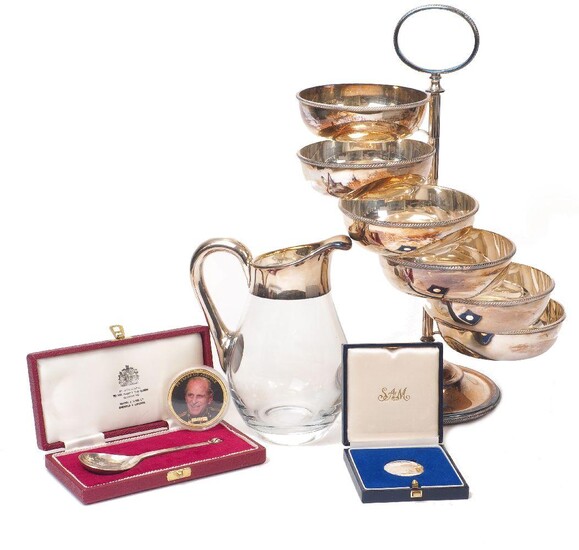 A swivel bowl centrepiece, designed with six small bowls rotating around central stem, the base stamped 'made in Italy, Christian Dior', together with a cased silver Mappin & Webb spoon, London, c.1973; a glass jug with silver plated handle; a...
