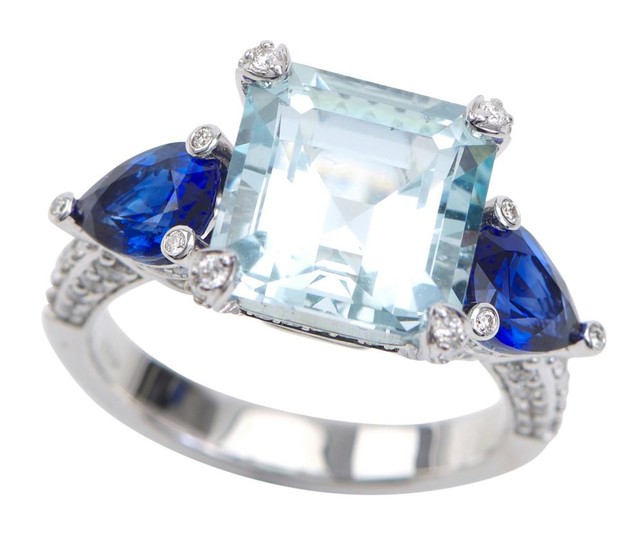AN AQUAMARINE, SAPPHIRE AND DIAMOND RING - Featuring a square emerald cut aquamarine weighing 6.38cts, flanked by trilliant cut sapp...