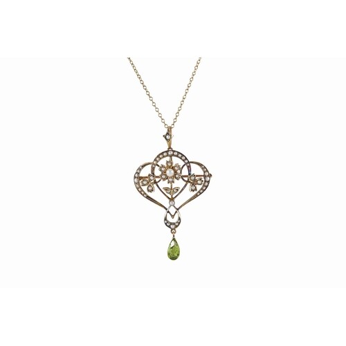 AN ART NOUVEAU SEED PEARL AND PERIDOT BROOCH, on a chain