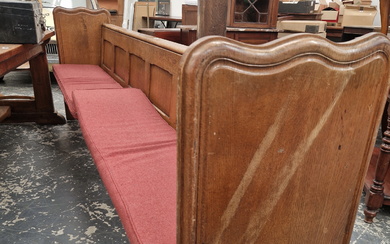 AN OAK PEW WITH PLANK ENDS AND WITH ANOTHER CENTRALLY. W 275cms.