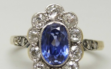 An 18ct gold, oval sapphire and diamond cluster ring, oval c...