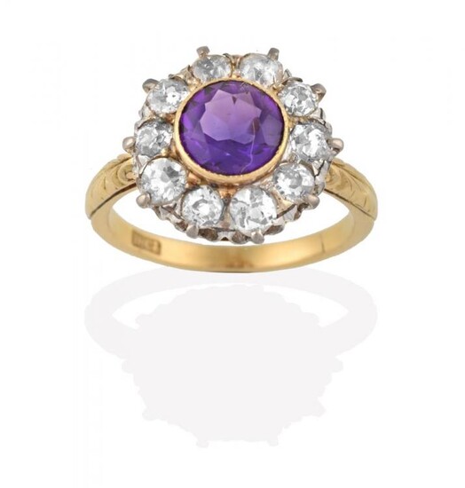 An Amethyst and Diamond Cluster Ring, the round cut amethyst...