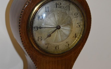 An Edwardian mahogany inlaid mantel clock, of balloon shape, raised on four brass metal feet