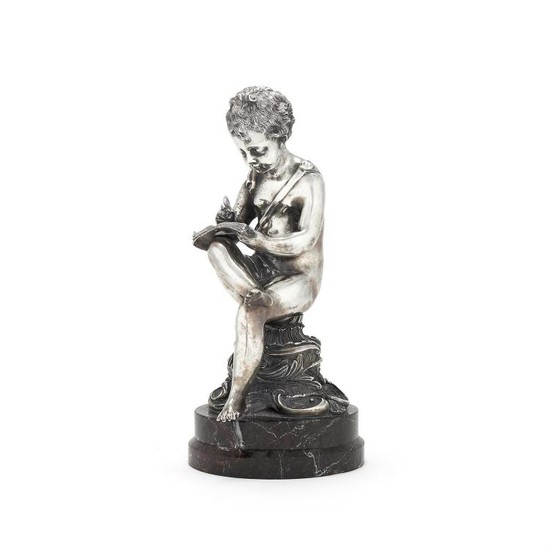 An Italian filled silver coloured figure of a seated putto writing