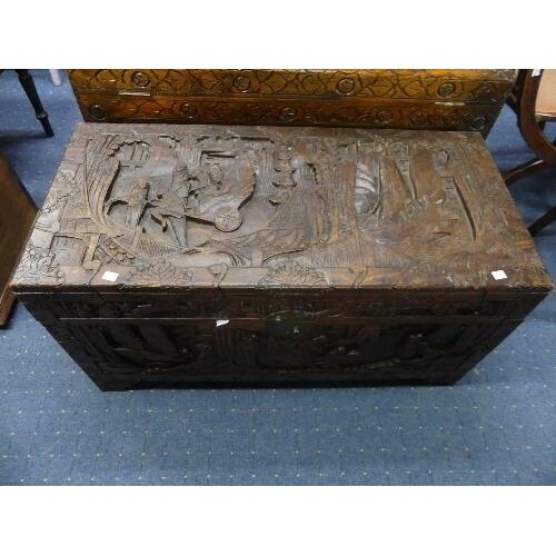 An Oriental camphorwood Chest, with carved decoration of an ...