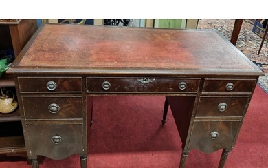 An early 20th Century Mahogany Kneehole Desk with burgundy t...