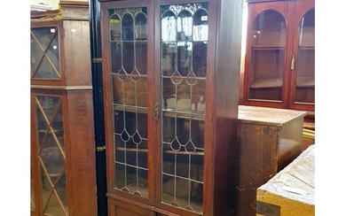An early 20th century oak bookcase, with leaded glazed panel...