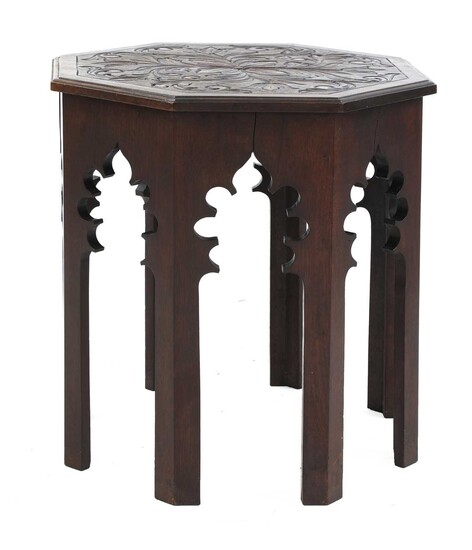 An octagonal mahogany lamp table