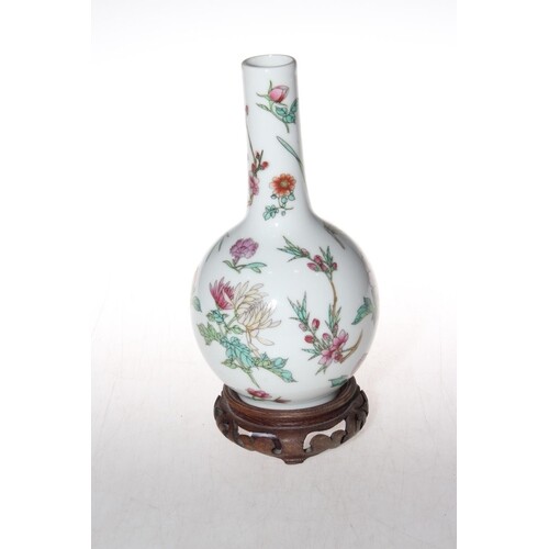 Chinese famille rose bottle neck vase on wood stand, red sea...