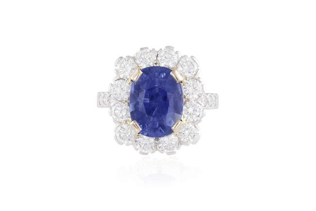 Description A SAPPHIRE AND DIAMOND CLUSTER RING The oval-shaped...
