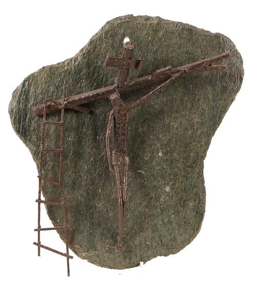 Een moderne bronzen crucifix op leisteen